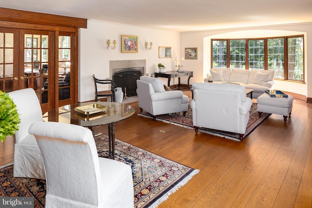 living room featuring french doors, a fireplace, and hardwood / wood-style floors