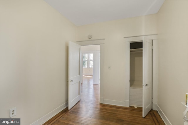 unfurnished bedroom featuring baseboards and wood finished floors