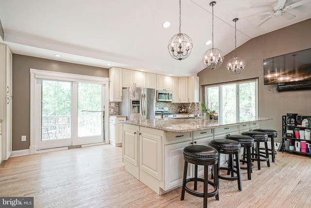 11 Lippincott Ave, Voorhees, NJ 08043 - kitchen featuring decorative backsplash, light stone countertops, recessed lighting, light wood finished floors, and stainless steel appliances
