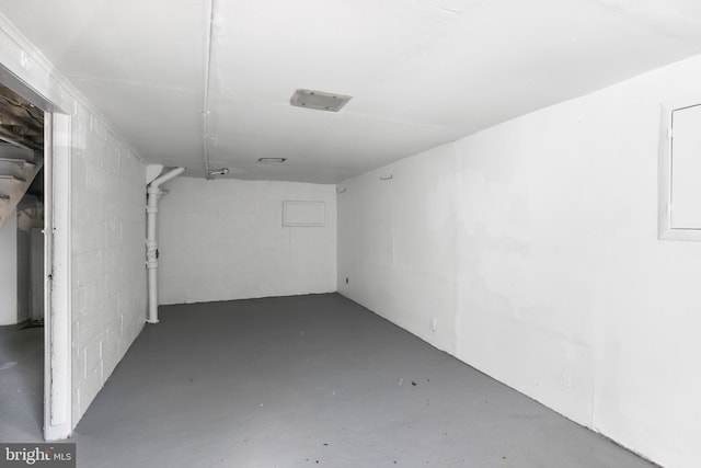 below grade area featuring concrete block wall