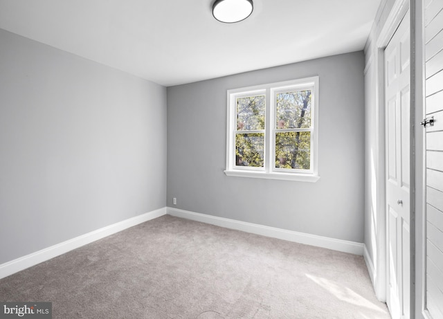 unfurnished bedroom with baseboards, a closet, and carpet