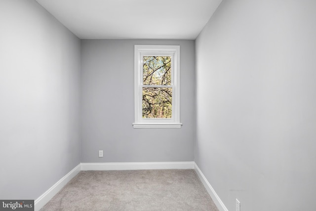 carpeted empty room with baseboards
