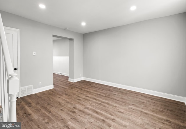 unfurnished room featuring recessed lighting, visible vents, wood finished floors, and baseboards