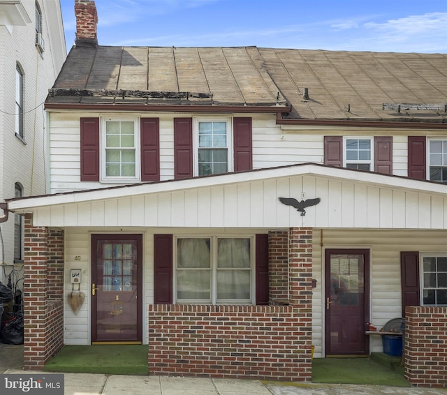 view of front of property with covered porch and brick siding