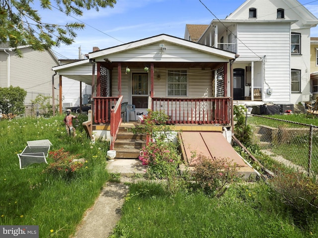view of front of property with fence and a porch