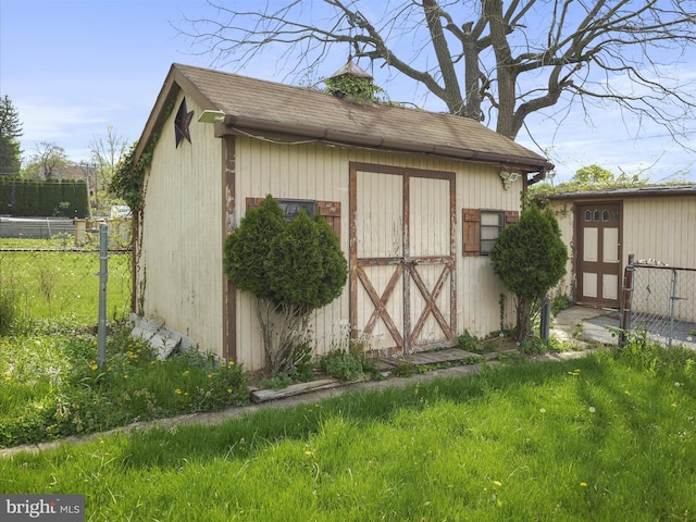 view of shed featuring fence