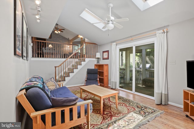 1602 Blacksmith Ln, Herndon, VA 20170 - living area featuring a skylight, a ceiling fan, wood finished floors, stairway, and high vaulted ceiling