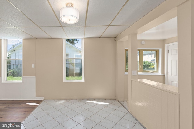 916 N Kresson St, Baltimore, MD 21205 - empty room featuring a wealth of natural light, light tile patterned flooring, and a drop ceiling