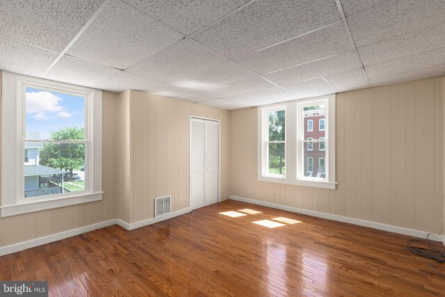 916 N Kresson St, Baltimore, MD 21205 - unfurnished bedroom featuring hardwood / wood-style floors, visible vents, baseboards, and a paneled ceiling