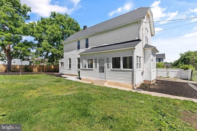 916 N Kresson St, Baltimore, MD 21205 - rear view of property featuring a lawn, fence private yard, entry steps, and roof with shingles