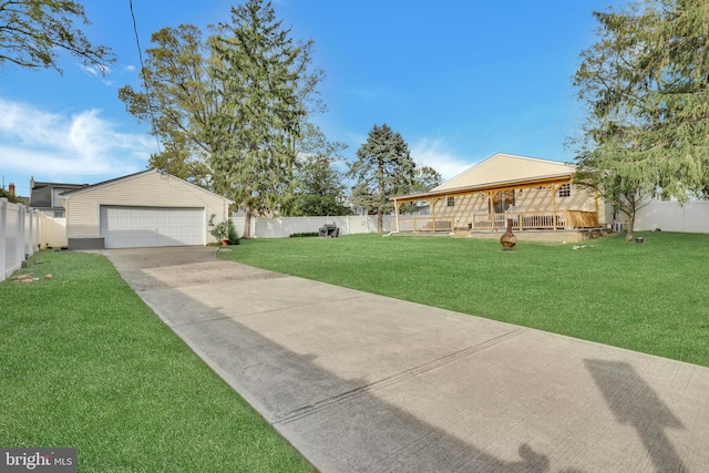 view of yard featuring a fenced backyard, an outbuilding, and a garage