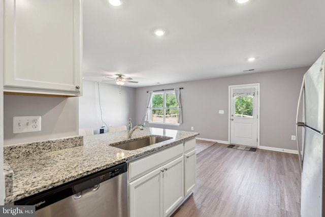 17026 Rollins Rd, Bowling Green, VA 22427 - kitchen with a sink, stainless steel appliances, light stone counters, ceiling fan, and white cabinets