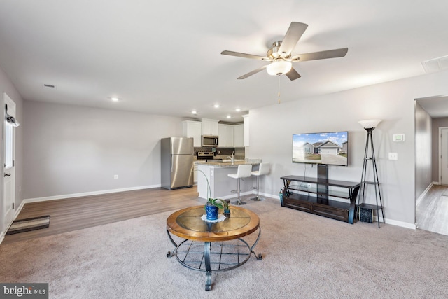 17026 Rollins Rd, Bowling Green, VA 22427 - living area with light colored carpet, ceiling fan, and baseboards