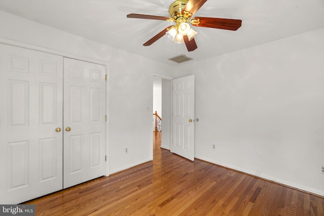 unfurnished bedroom featuring a closet, baseboards, visible vents, and light wood-type flooring