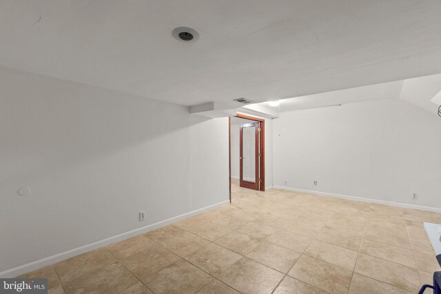 interior space featuring baseboards and light tile patterned floors