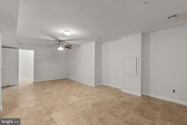 spare room with baseboards and a ceiling fan