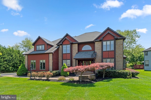 view of front of property with brick siding and a front yard