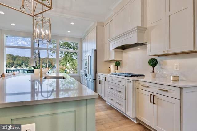 1634 Orchard Beach Rd, Annapolis, MD 21409 - kitchen with a sink, stainless steel appliances, light countertops, ornamental molding, and a notable chandelier