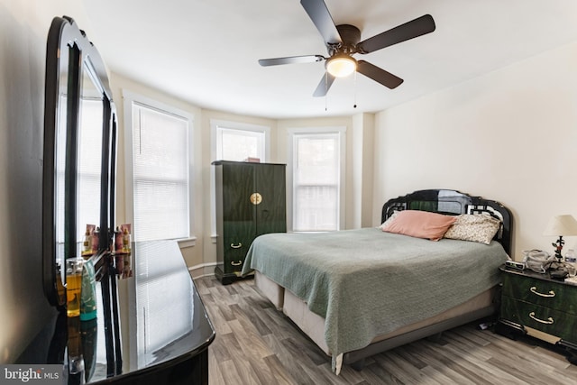 bedroom with wood finished floors and ceiling fan