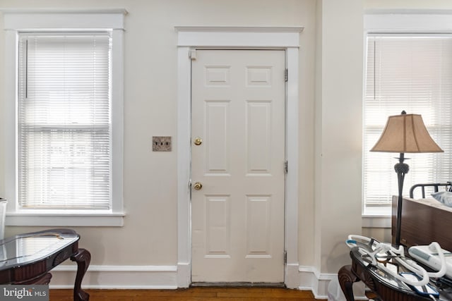 entryway with wood finished floors and baseboards