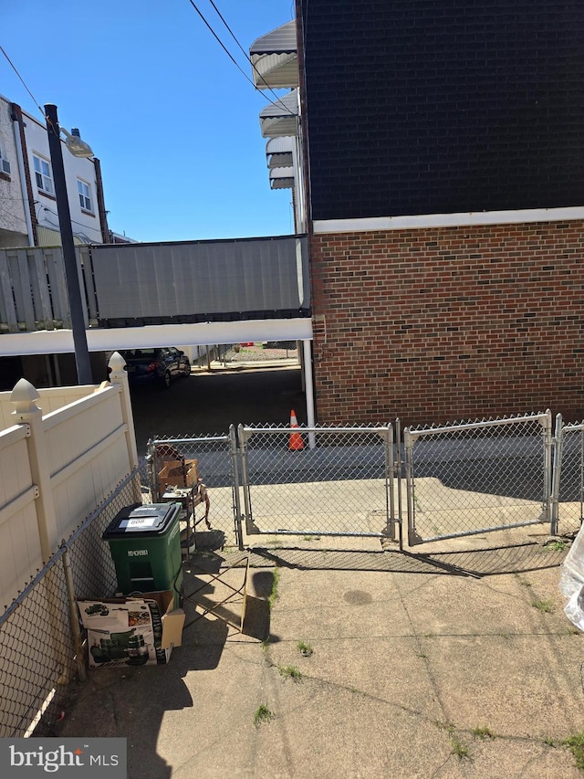 view of patio featuring a gate and fence
