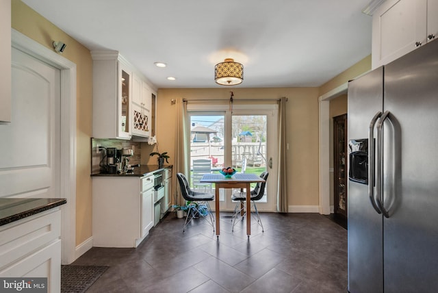 kitchen featuring recessed lighting, glass insert cabinets, stainless steel refrigerator with ice dispenser, and white cabinetry