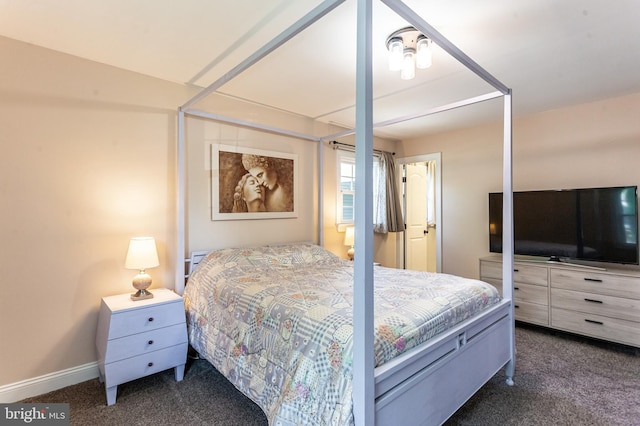bedroom featuring baseboards and dark colored carpet