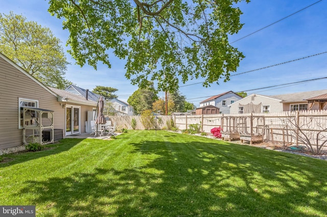 view of yard with a patio, a fenced backyard, and a residential view