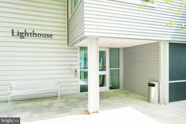 view of exterior entry featuring a patio area
