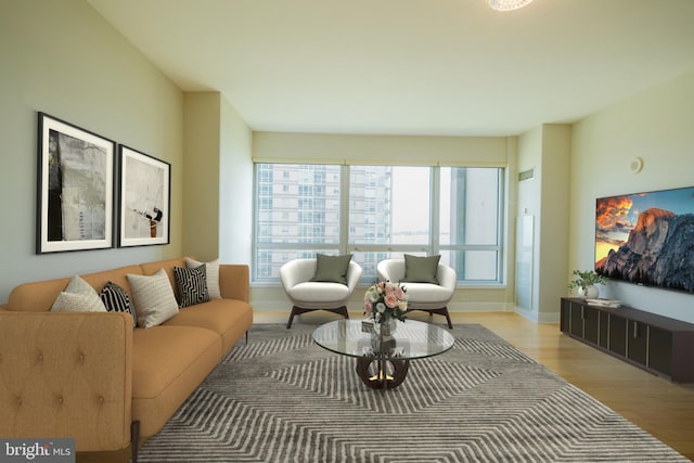 living area with light wood-style floors and baseboards