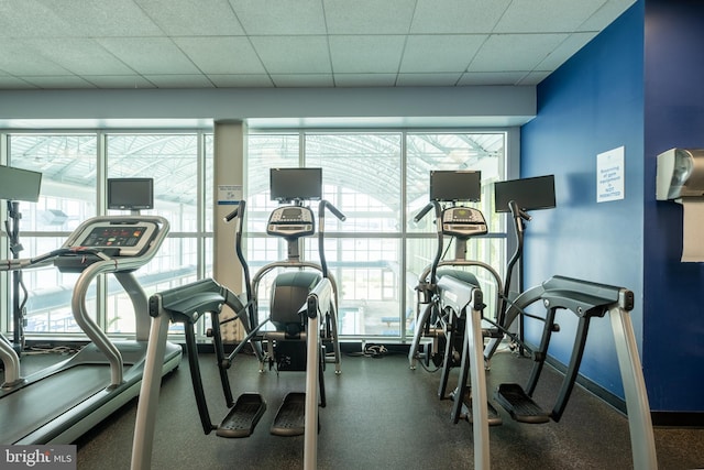 workout area with a paneled ceiling
