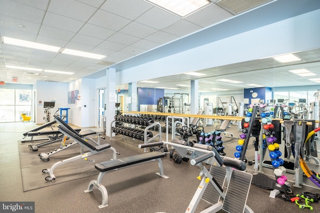 workout area featuring visible vents, a healthy amount of sunlight, and a drop ceiling