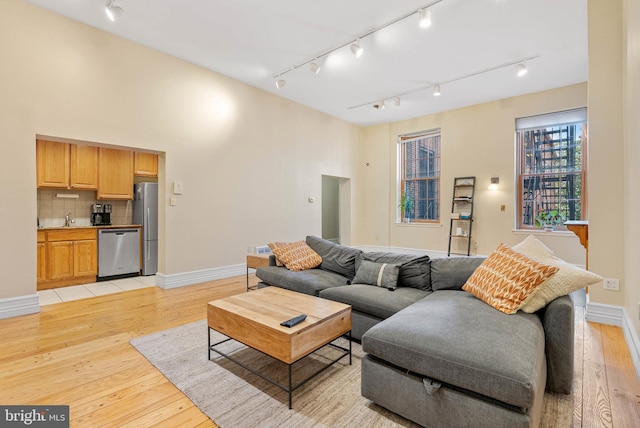 914 Spruce St Unit 9, Philadelphia, PA 19107 - living area with baseboards, rail lighting, and light wood-style floors