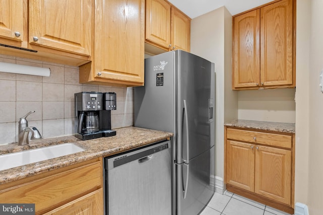 914 Spruce St Unit 9, Philadelphia, PA 19107 - kitchen with a sink, stainless steel appliances, light tile patterned flooring, light stone countertops, and backsplash