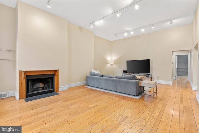 914 Spruce St Unit 9, Philadelphia, PA 19107 - living room with track lighting, baseboards, a fireplace with flush hearth, and light wood-style flooring