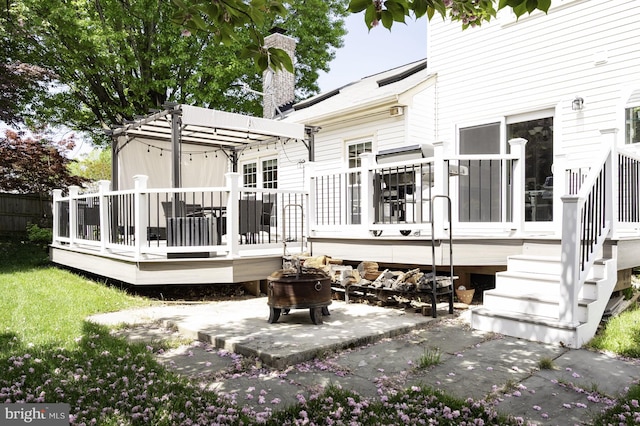 5433 Lomax Way, Woodbridge, VA 22193 - back of house featuring a wooden deck, a patio area, a chimney, and a fire pit