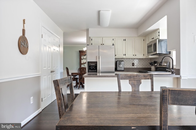 5433 Lomax Way, Woodbridge, VA 22193 - kitchen featuring stainless steel appliances, backsplash, white cabinets, dark countertops, and dark wood-style flooring