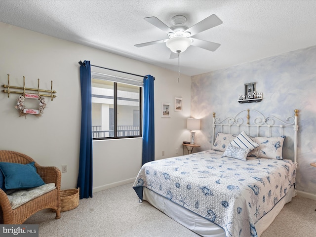 carpeted bedroom featuring a ceiling fan, a textured ceiling, and baseboards