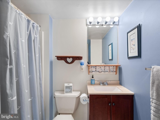 bathroom featuring vanity, a shower with shower curtain, and toilet