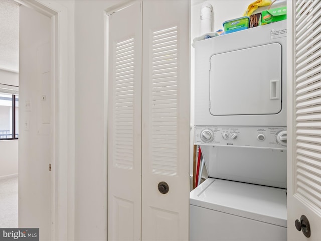 washroom with laundry area and stacked washer and clothes dryer