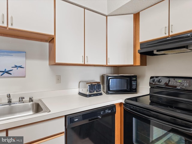 kitchen featuring a sink, light countertops, white cabinetry, under cabinet range hood, and black appliances