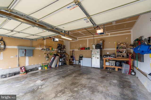 7815 Outing Ave, Pasadena, MD 21122 - garage with freestanding refrigerator, a workshop area, a garage door opener, and electric panel