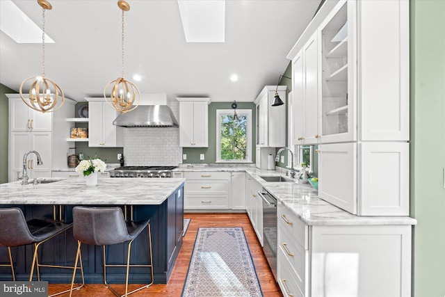 4812 Maury Ln, Alexandria, VA 22304 - kitchen featuring wall chimney range hood, a skylight, and a sink