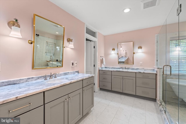 4812 Maury Ln, Alexandria, VA 22304 - bathroom with visible vents, marble finish floor, two vanities, a sink, and a stall shower