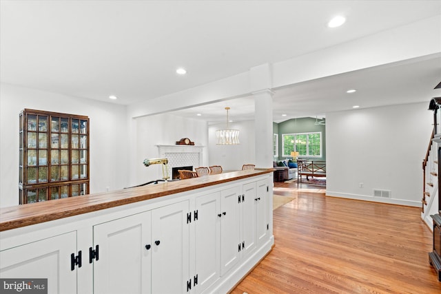 4812 Maury Ln, Alexandria, VA 22304 - kitchen with light wood finished floors, butcher block countertops, recessed lighting, open floor plan, and a tile fireplace