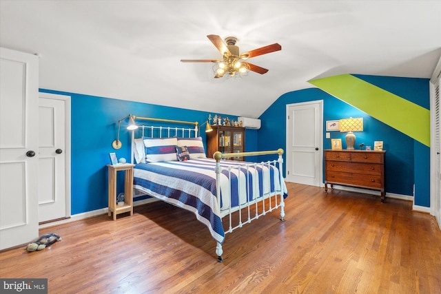 4812 Maury Ln, Alexandria, VA 22304 - bedroom featuring baseboards, vaulted ceiling, wood finished floors, and a wall mounted air conditioner