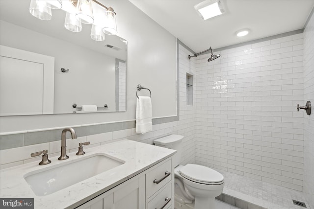 4812 Maury Ln, Alexandria, VA 22304 - bathroom featuring vanity, toilet, tile walls, visible vents, and tiled shower