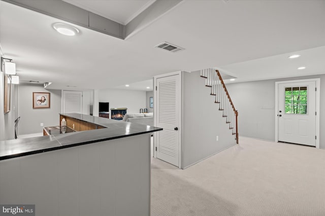 4812 Maury Ln, Alexandria, VA 22304 - kitchen featuring a warm lit fireplace, dark countertops, visible vents, and recessed lighting
