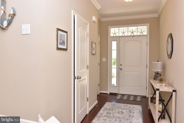 foyer entrance with baseboards, ornamental molding, and dark wood finished floors