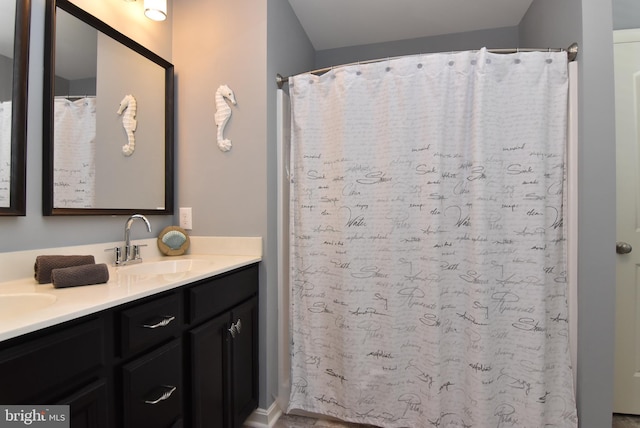 full bath featuring double vanity and a sink